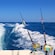 The wake of a powerboat with 2 fishing rod holders